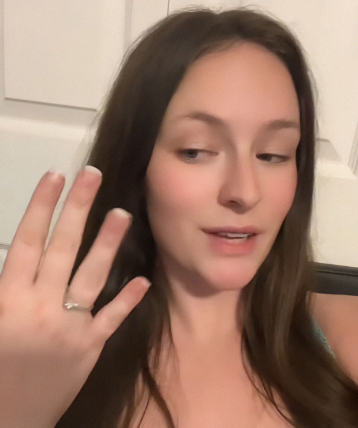 Woman showing engagement ring, proud of fianc&eacute;'s proposal at another wedding, sparks fury online.