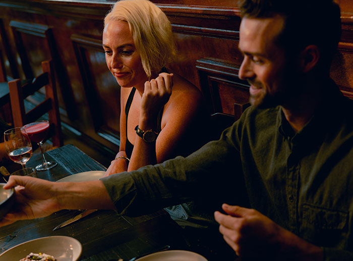 A couple dining in a cozy restaurant, capturing a moment that sparks stories about giving "nice guys" a chance.