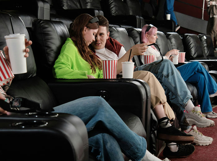 People in a theater with popcorn, highlighting stories about women and "nice guys."