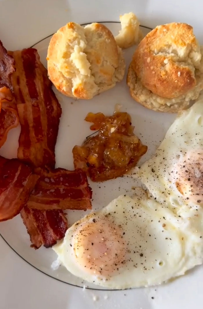 Plate with fried eggs, bacon, and biscuits, tied to Gwyneth Paltrow and Meghan Markle feud rumors.