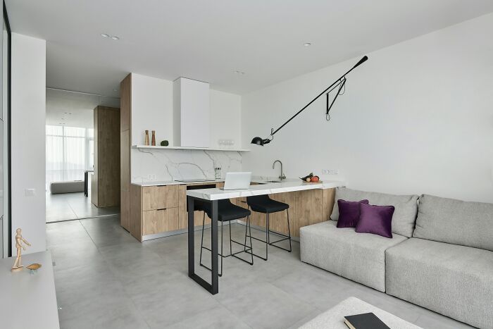 Modern kitchen and living area with minimalist decor, showcasing effective cleaning hacks impact.