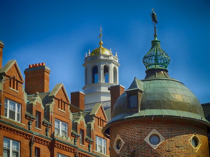 Harvard's historic buildings under a clear blue sky, symbolizing free tuition announcement for families earning $200K or less. Harvard's historic buildings under a clear blue sky, symbolizing free tuition announcement for families earning $200K or less.