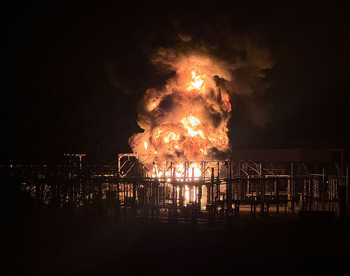 Explosion at Heathrow Airport causing chaos, massive fireball illuminates night sky.