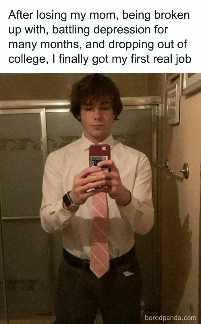 Young man in formal attire taking a mirror selfie, sharing a positive and uplifting post about overcoming challenges.