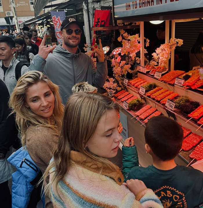 Man in sunglasses makes a peace sign at a food stall with son and others, stirring outrage online. Man in sunglasses makes a peace sign at a food stall with son and others, stirring outrage online.
