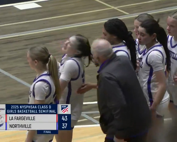 Basketball coach interacts with female player during 2025 NYSPHSAA semifinal, with La Fargeville winning 43-37 over Northville.