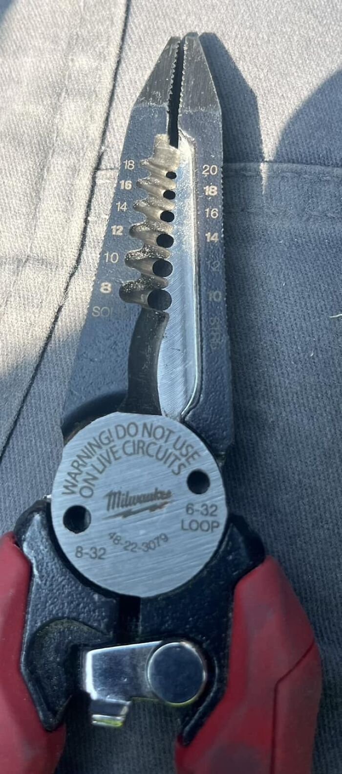 Tool with safety warning label about circuits, highlighting a big mistake aftermath.