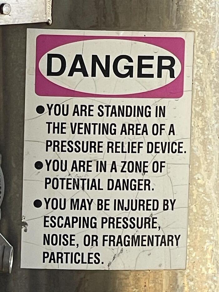 Danger sign warning of potential injury from escaping pressure and noise in a venting area.