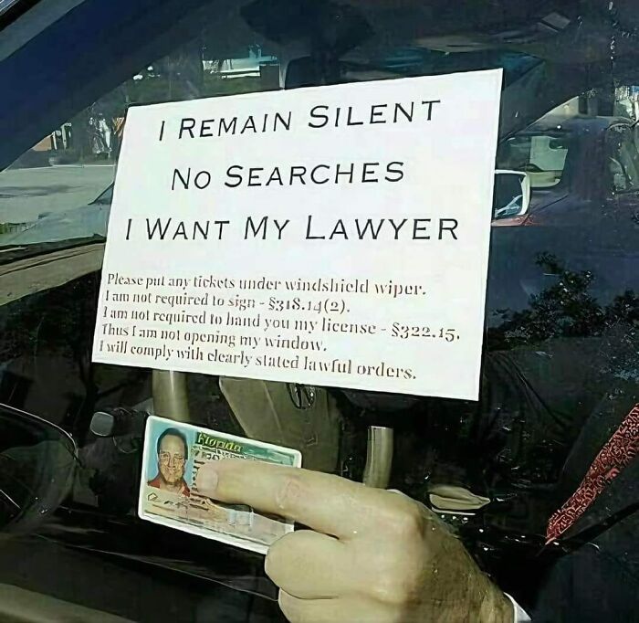 Car window sign displaying legal statement and driver's license, symbolizing aftermath of someone's mistake.