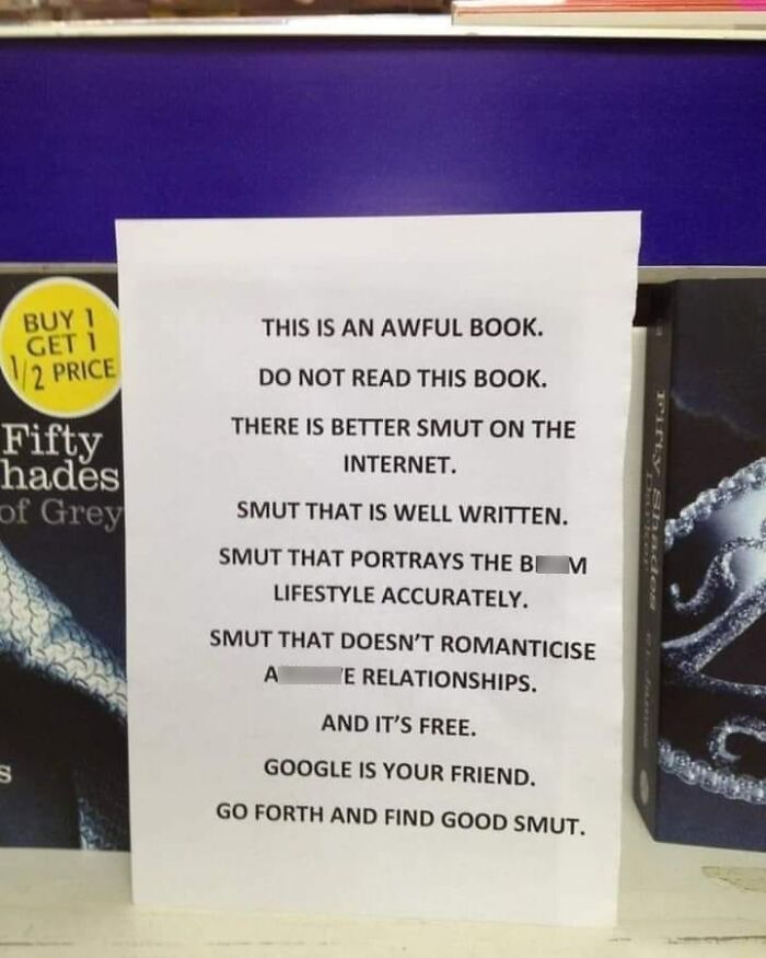 Sign criticizing book with message about finding better written smut online as a warning sign of a big mistake.