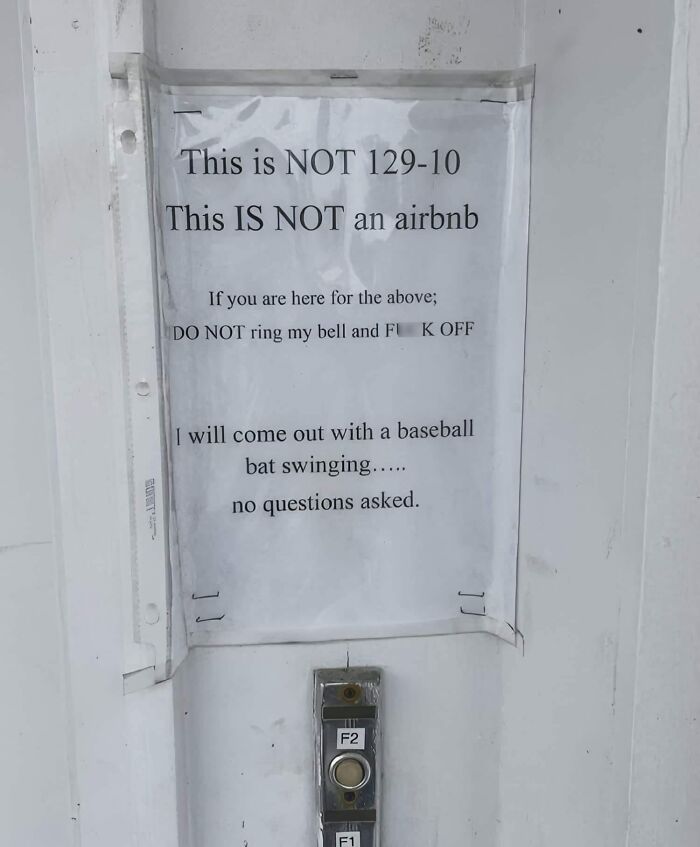 Door with a warning sign, emphasizing not being an Airbnb, illustrating a mistake aftermath.