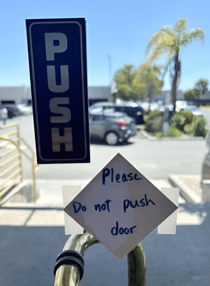 Door with conflicting push and do not push signs, illustrating a common mistake aftermath.