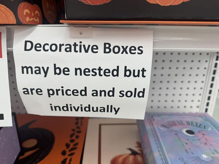 Sign displaying warning about pricing of nested decorative boxes.