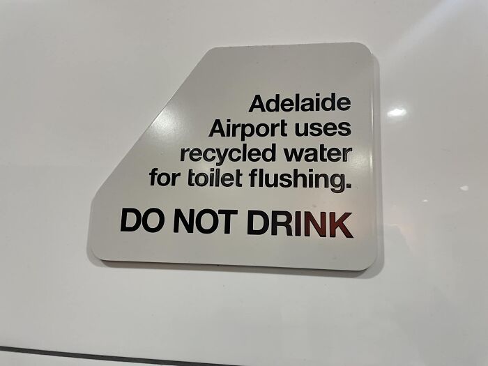 Sign warning about recycled water use for toilet flushing, not for drinking, at Adelaide Airport.