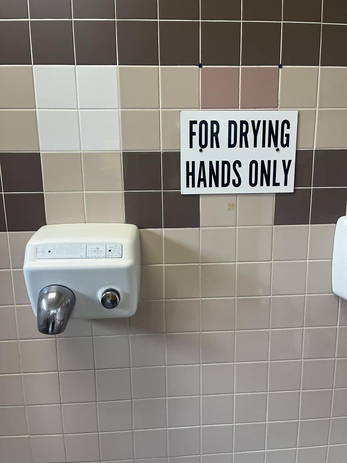 Hand dryer with sign stating "For Drying Hands Only," highlighting a potential big mistake.