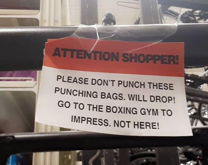 Sign warns shoppers not to punch bags to avoid mistakes, suggesting a gym instead.