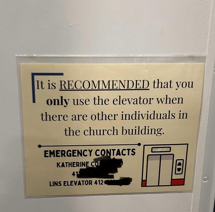 Elevator warning sign in church advising to ride only with others, listing emergency contacts.