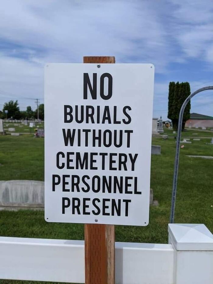 Sign in cemetery warns: "No burials without cemetery personnel present."