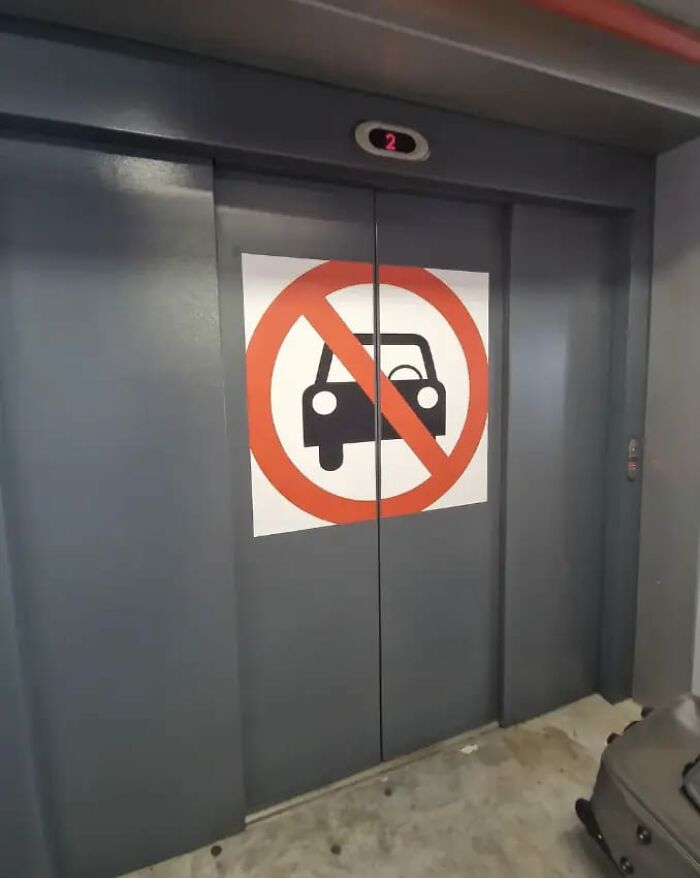 Elevator door with a no cars warning sign, illustrating a big mistake aftermath.