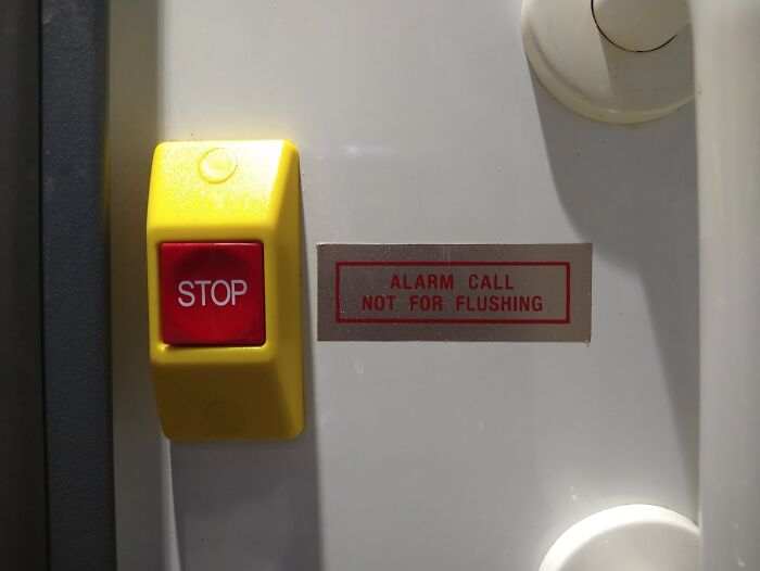 "Alarm button with warning sign, indicating a potential mistake in intended use."