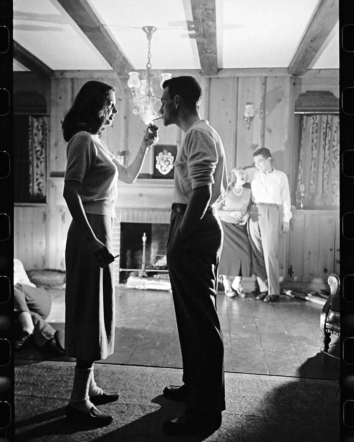 Vintage photo of people in a room, featuring social interactions from forgotten corners of history.