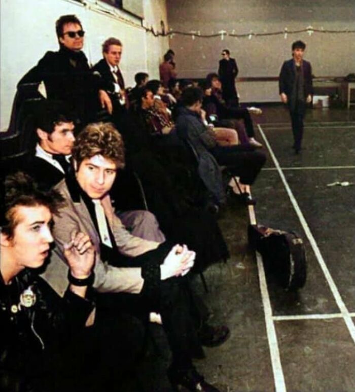 Group of young people in a vintage setting, capturing forgotten corners of history with distinctive 80s style.