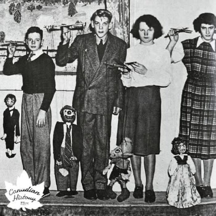 Children displaying puppets from forgotten corners of history, showcasing vintage toys and fashion.