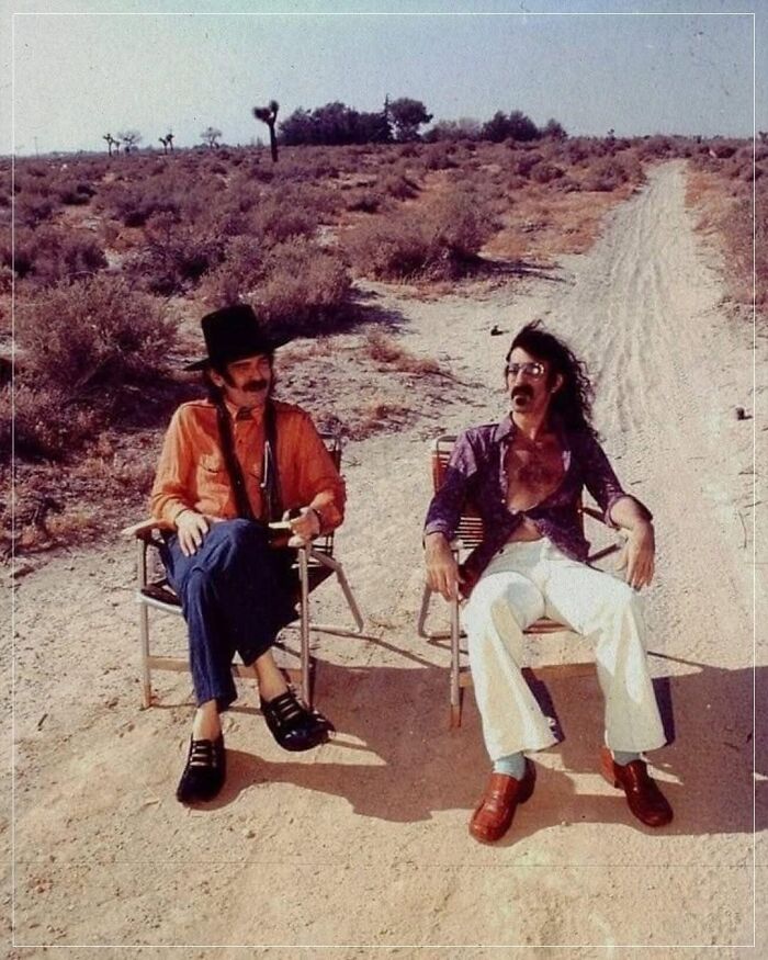 Two men sitting in chairs by a desert path, capturing a forgotten corner of history.