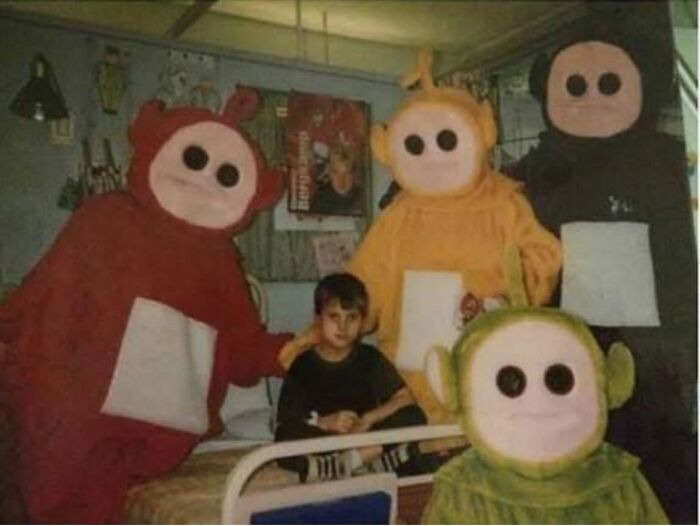 Children's characters posing with a young boy on a bed, showcasing forgotten corners of history.