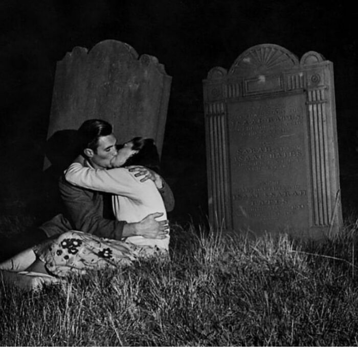A couple kissing in a forgotten graveyard, illustrating a corner of history.