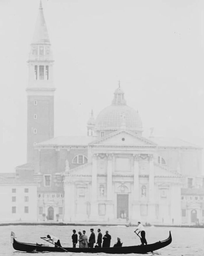 Gondola with people on a canal in front of historic Venetian architecture, capturing forgotten corners of history.