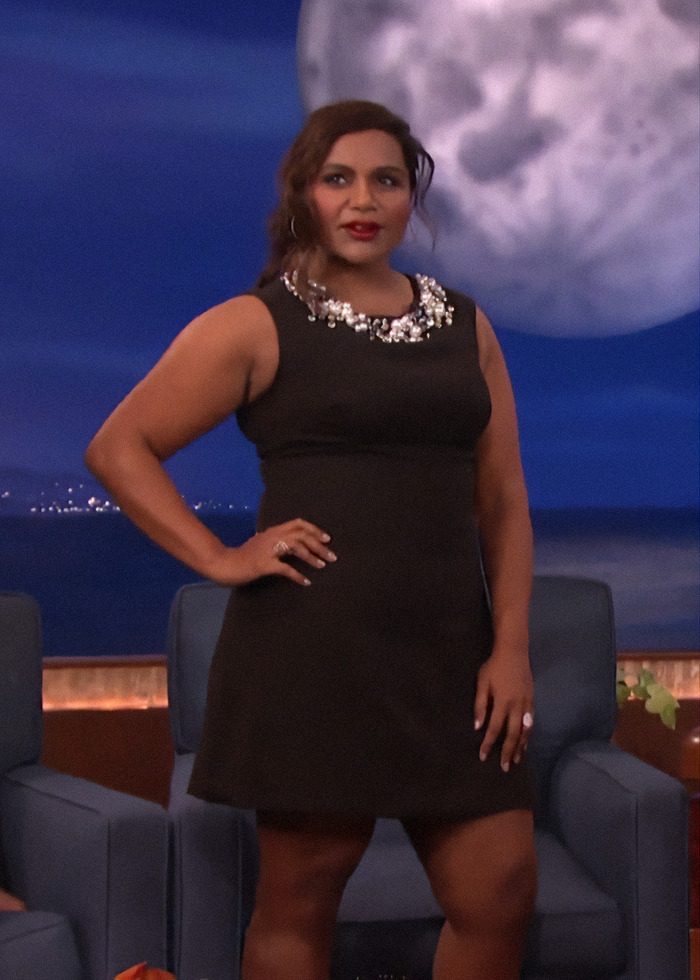 A person in a black dress on a talk show set, reflecting changing beauty standards in Hollywood. A person in a black dress on a talk show set, reflecting changing beauty standards in Hollywood.