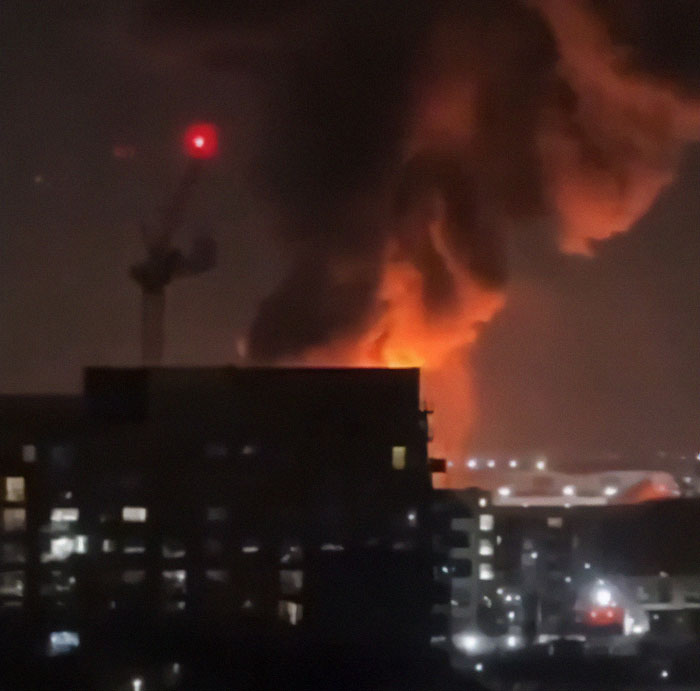Heathrow Airport explosion chaos, huge smoke and flames at night.