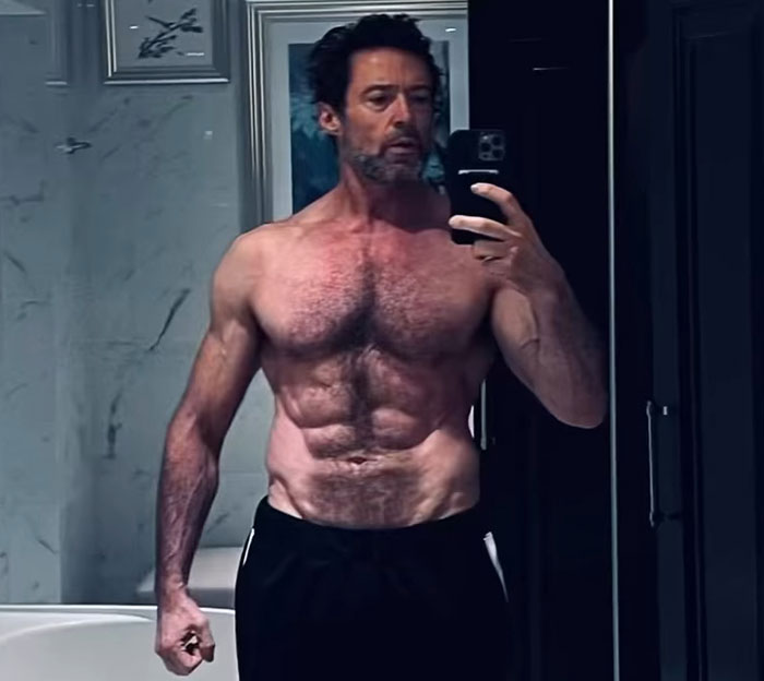 Man in a bathroom mirror selfie showcasing a fit physique, connected to a "70s Pawn Star" transformation.