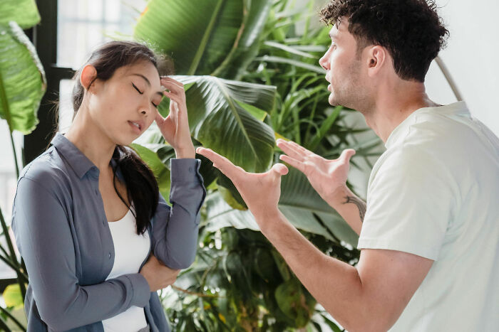 Man and woman arguing in front of plants, highlighting marital conflict and potential divorce scenario. Man and woman arguing in front of plants, highlighting marital conflict and potential divorce scenario.