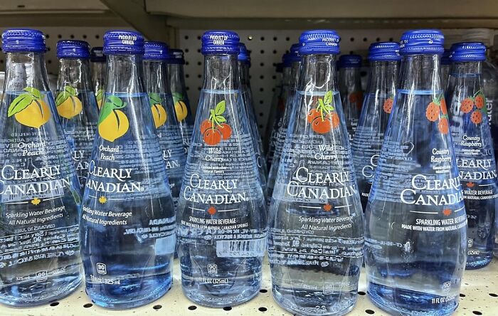Clearly Canadian sparkling water bottles on a store shelf, a nostalgic discontinued product from the past.