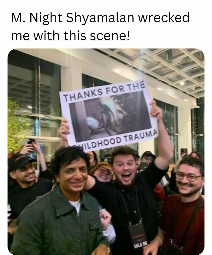 Group of people holding a sign about childhood trauma, evoking nostalgia for those who know floppy disks.