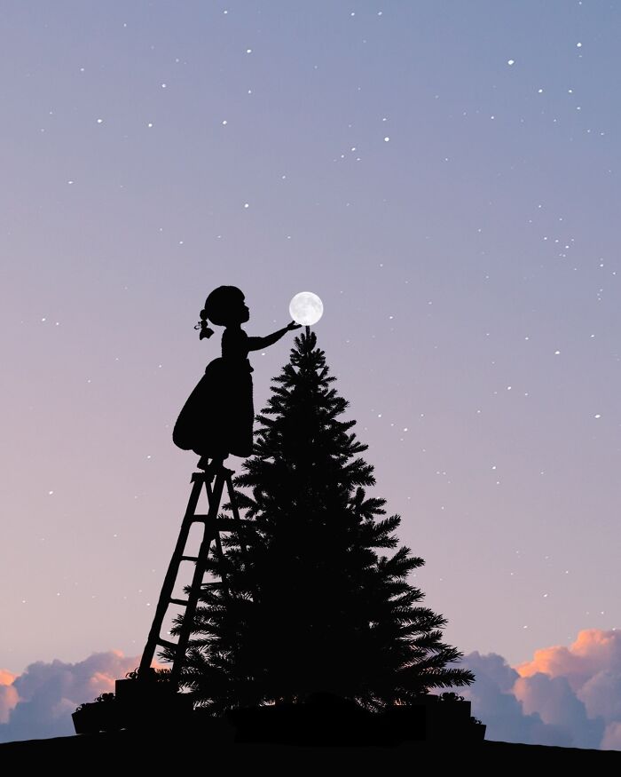 Silhouette of a girl on a ladder reaching for the full moon beside a tree against a twilight sky.