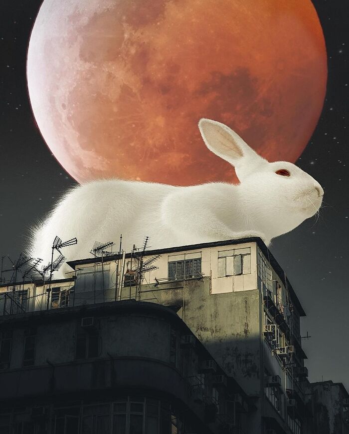 Surreal digital artwork of a giant white rabbit on a building with a red moon in the background.