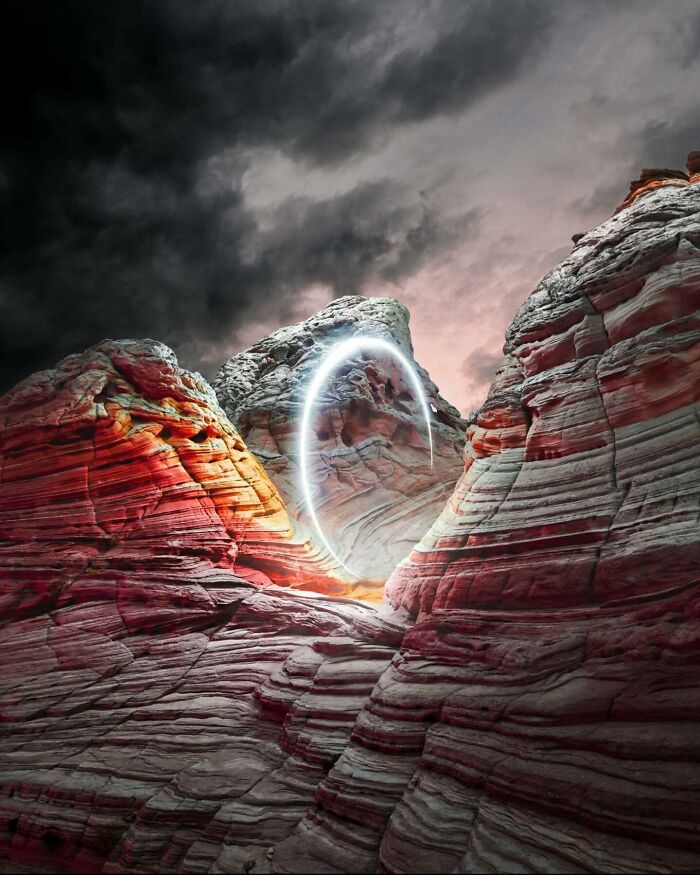 Drone lighting illuminates a rocky landscape under dramatic skies, creating a surreal scene by Reuben Wu.