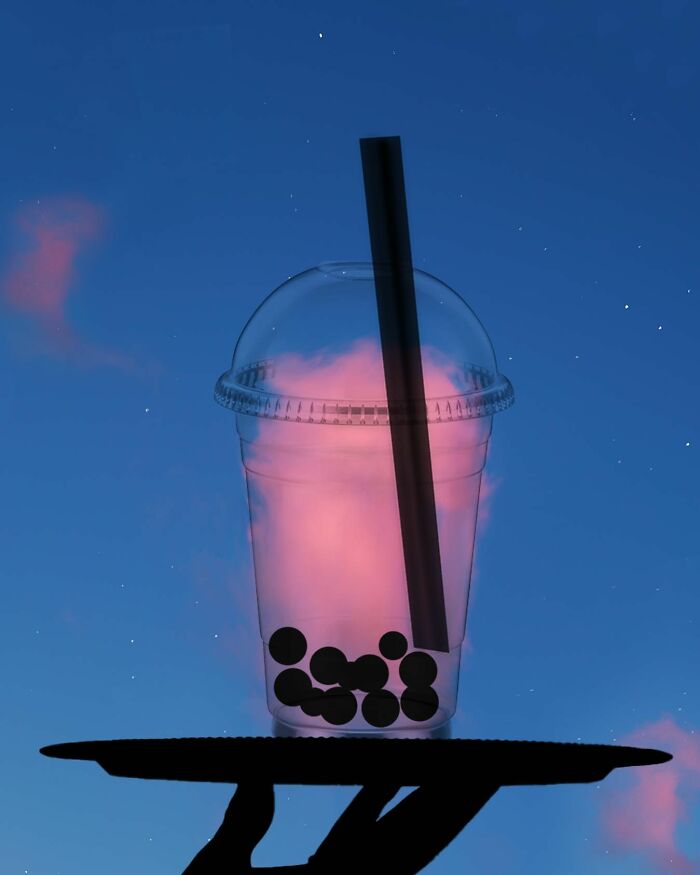 Silhouette photography of a bubble tea cup against a pink and blue sky by Lân Nguyen.