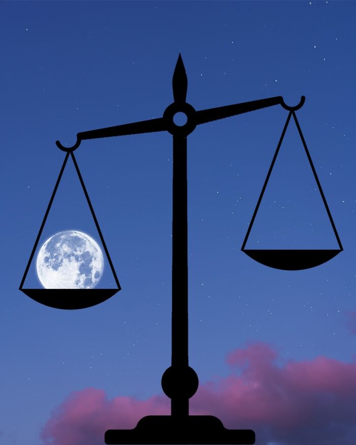 Silhouette of scales balancing the moon against a starry sky in silhouette photography.