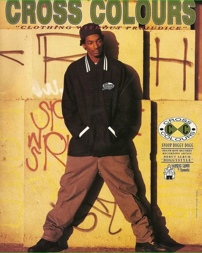 Snoop Dogg posing in streetwear for Cross Colours, highlighting rap royalty and business influence.