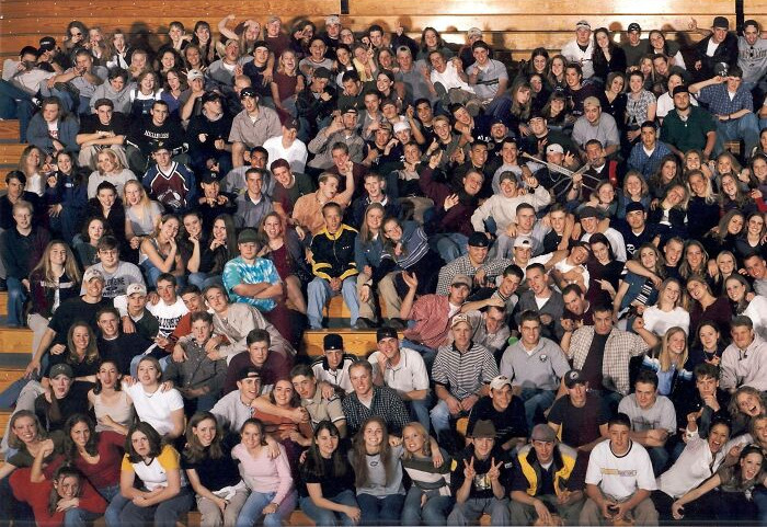Large group photo with people in a gymnasium, linked to creepy photo histories.