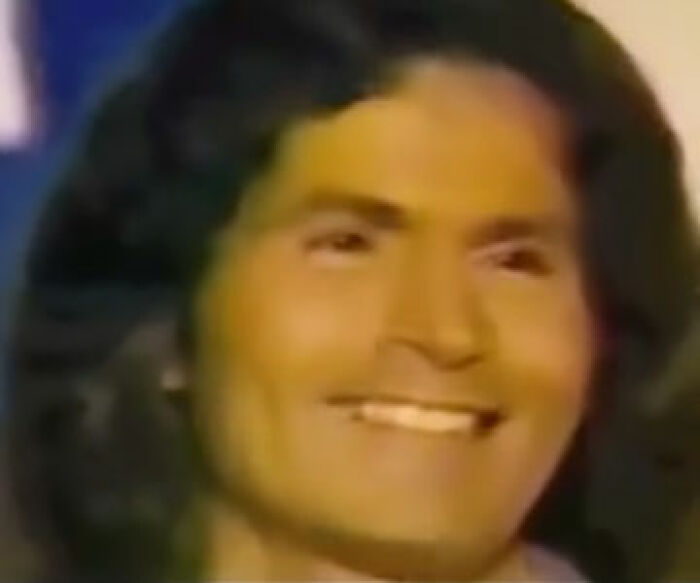 Portrait of a smiling person with long dark hair. The eerie context adds to the photo's creepy aura.