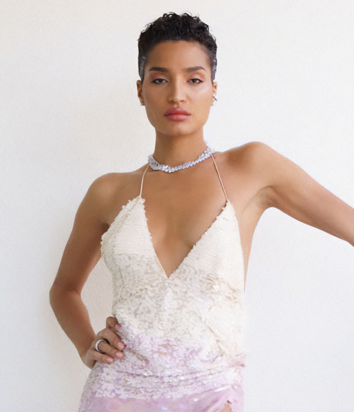 A transgender actor in a stylish dress, showcasing transformation in the movie industry.