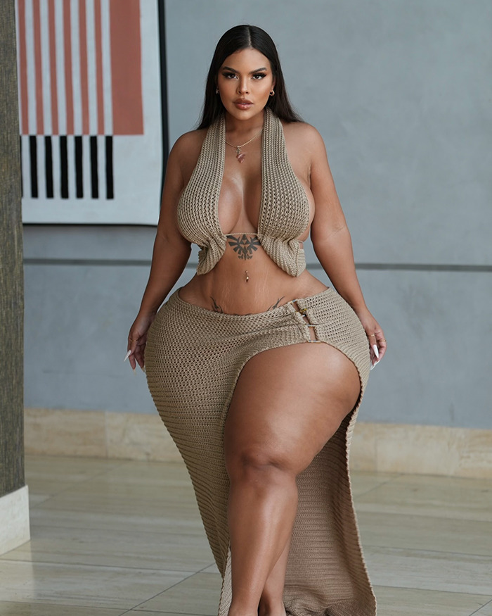Plus-size influencer posing confidently in a stylish beige outfit. Plus-size influencer posing confidently in a stylish beige outfit.
