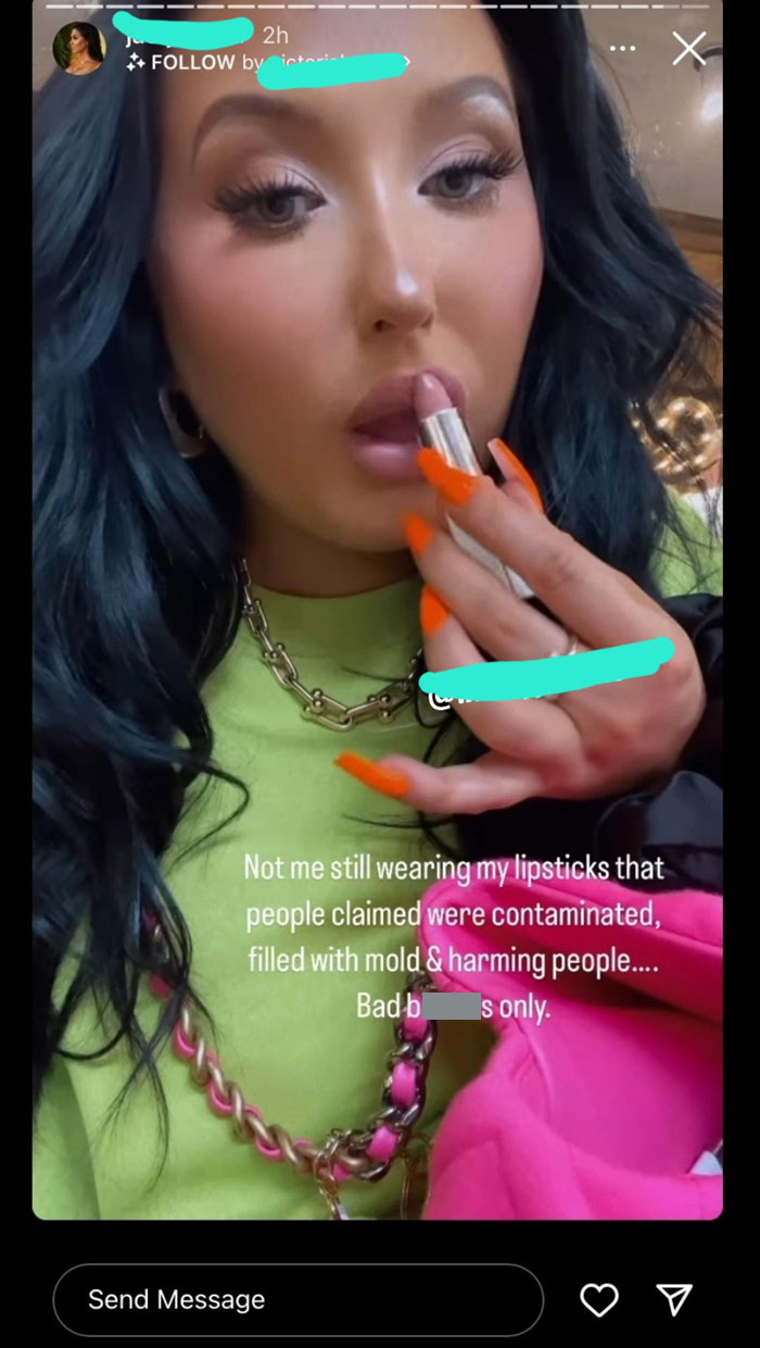 Influencer applying lipstick, showcasing entitled behavior in a controversial social media post.