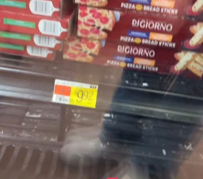 Grocery store display showing DiGiorno pizza priced at $9.92 in the US.