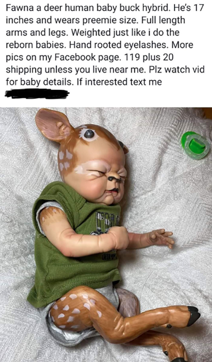 Creepy handmade craft of a deer-human hybrid baby doll in green clothing, lying on a blanket with a pacifier nearby.